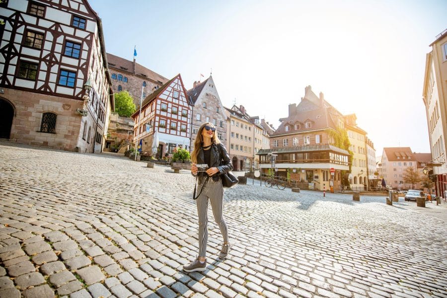 Young woman tourist walking on the beautiful city square in the old town of Nurnberg, Germany