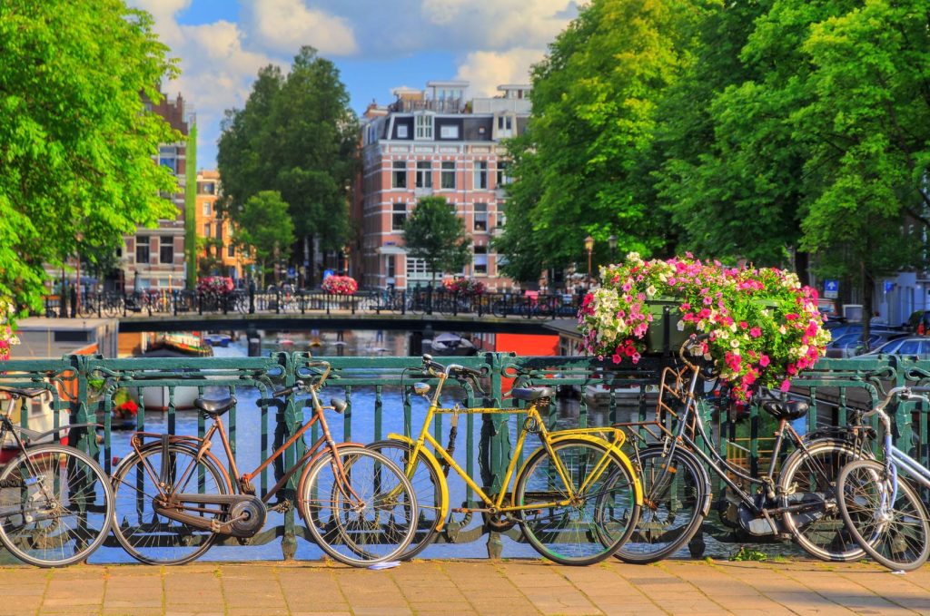 Beautiful vibrant summer flowers and bicycles on a bridge on the