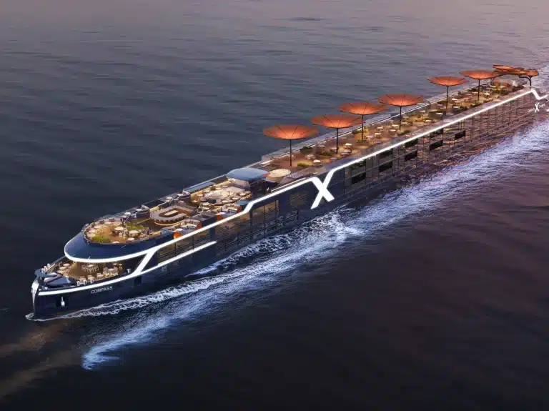 Rendered view of a sleek dark-hulled ship with glowing white stripes and orange umbrellas on its deck.