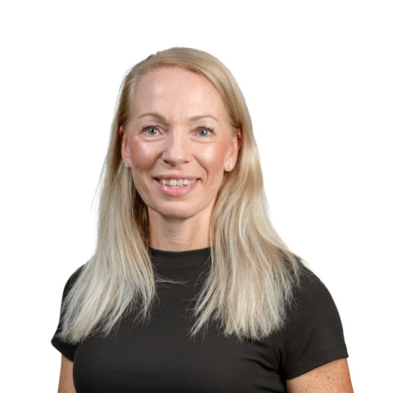 Smiling blonde woman wearing a black top, cropped at the shoulders.
