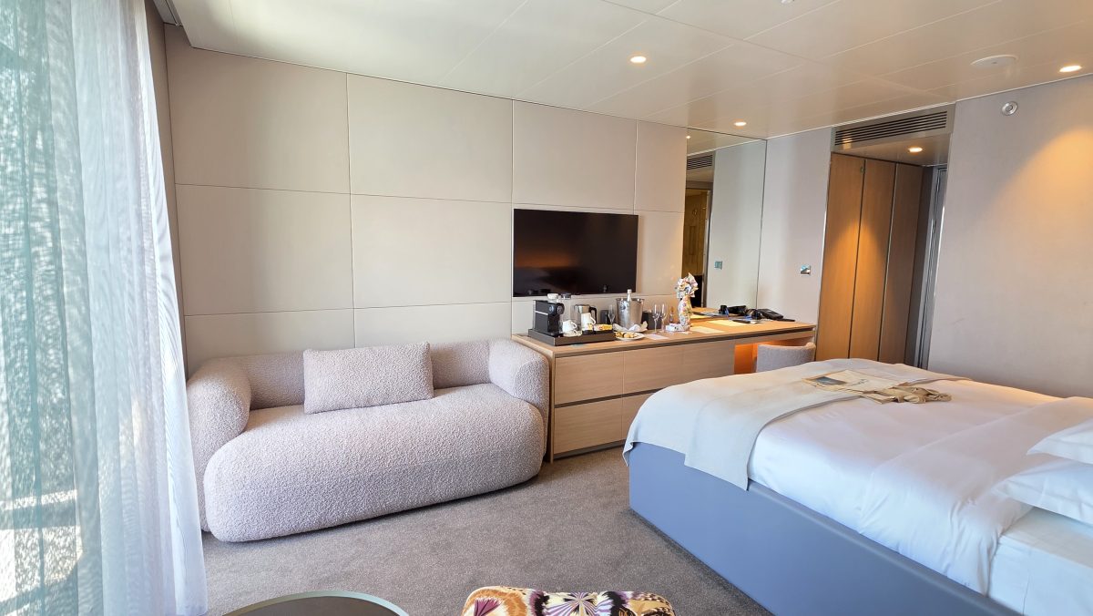 Balcony suite lounge area and cabinet on the Emerald Kaia
