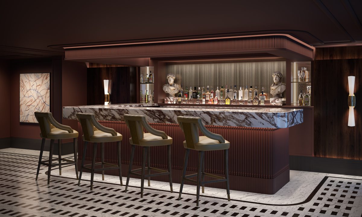 Luxurious hotel bar featuring a marble-front counter, brown wood panels, and upholstered bar stools lined up along the counter.