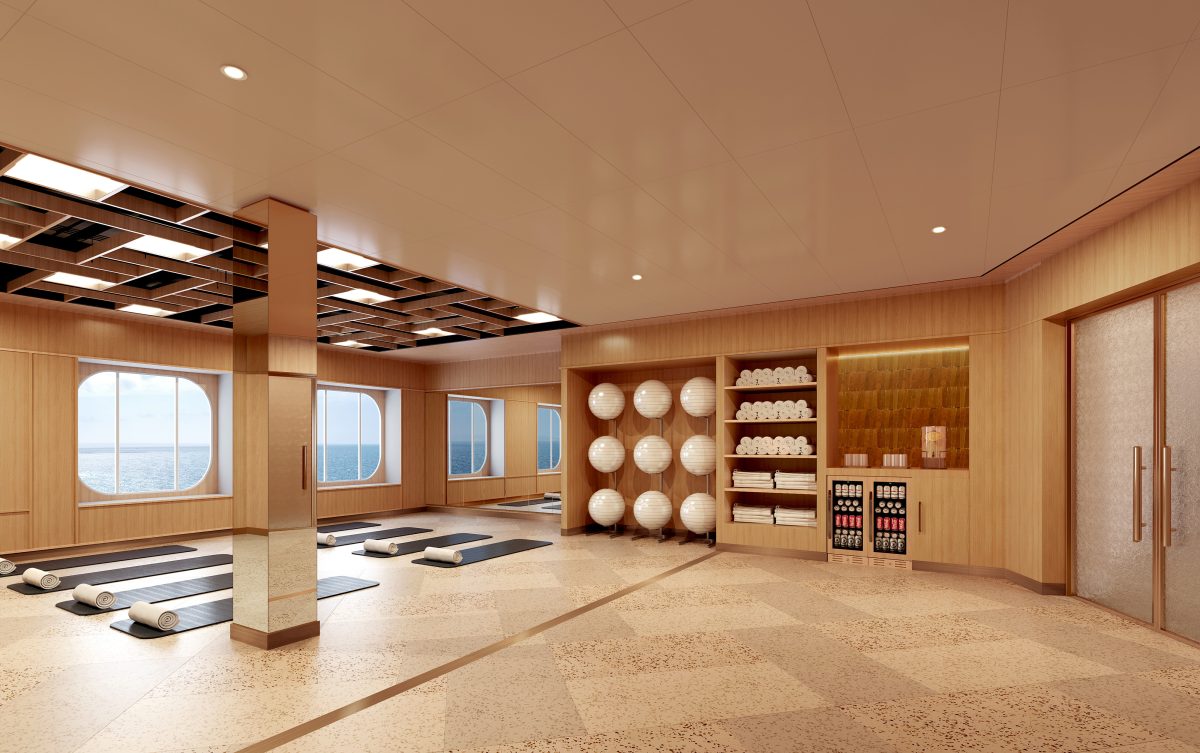 Spacious spa or gym on a ship with wooden walls, yoga mats, and neatly stacked towels by shelves overlooking the sea.
