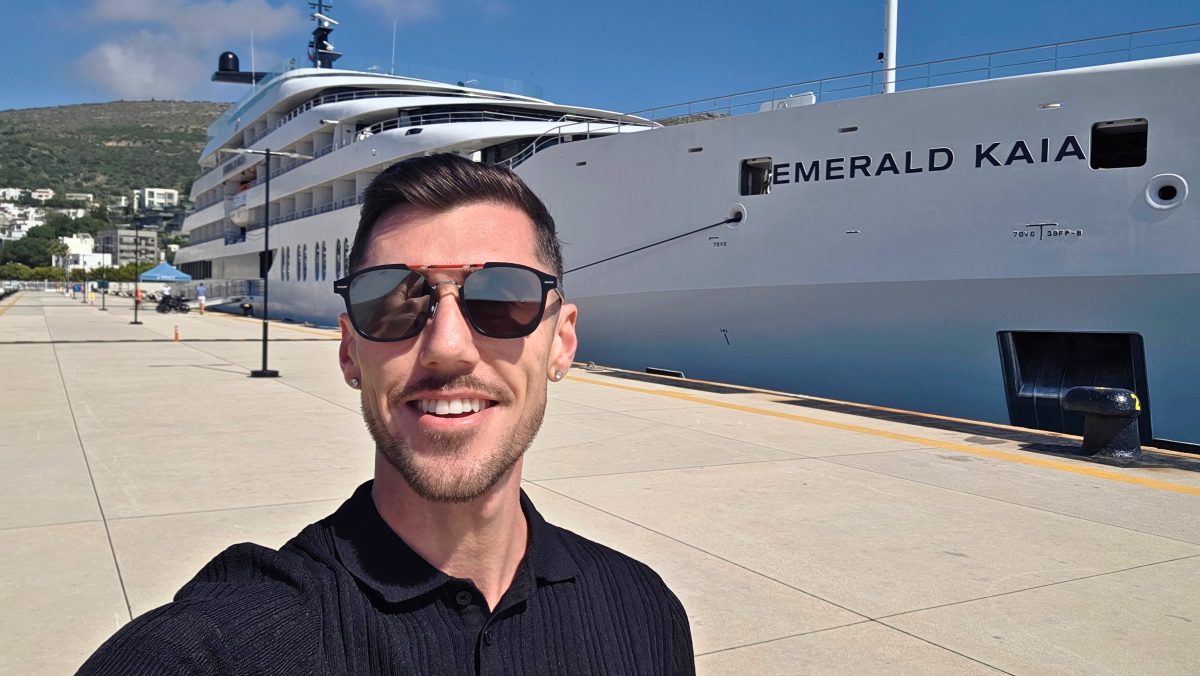 Marketing Manager, Blake Hatton in front of the Emerald Kaia Superyacht