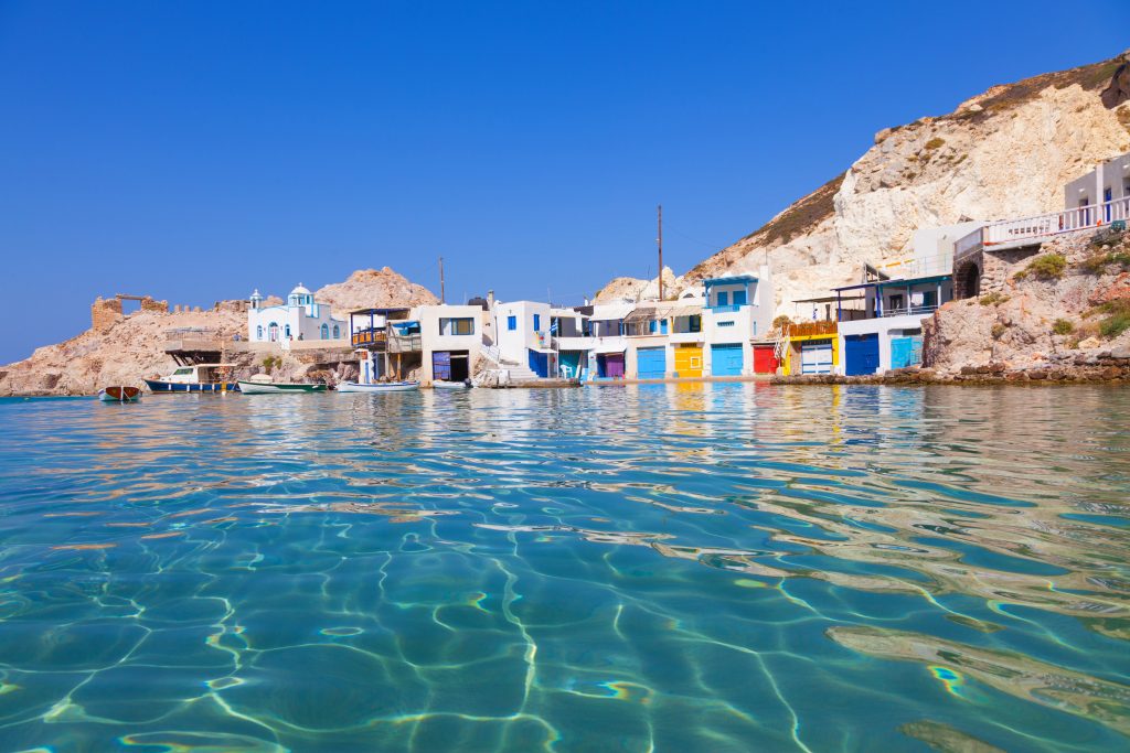 Clear turquoise waters and typical greek fishing village