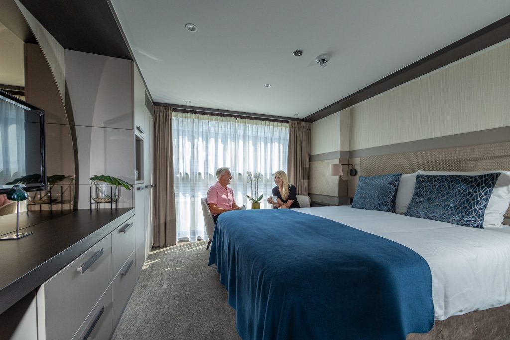 Couple relaxing in a suite on board Travelmarvel Capella